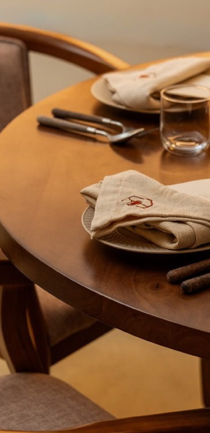 Round table set with embroidered napkins