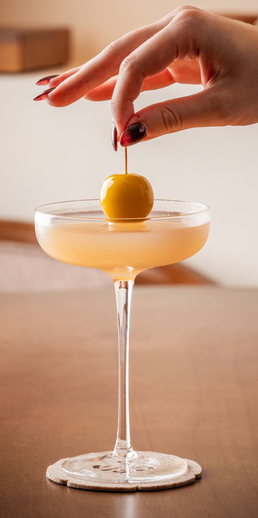Alcohol-free cocktail garnished with a golden cherry